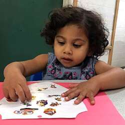 A girl playing with stickers